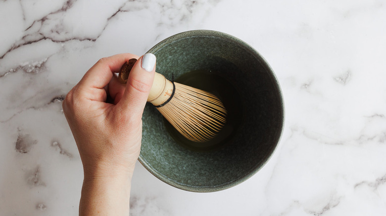 Whisking water and matcha powder