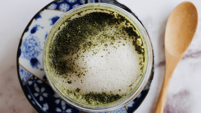 matcha latte on blue plate with spoon