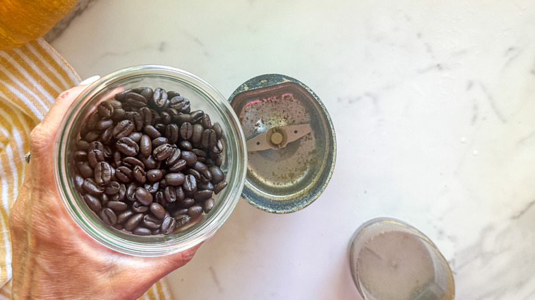 coffee beans over grinder