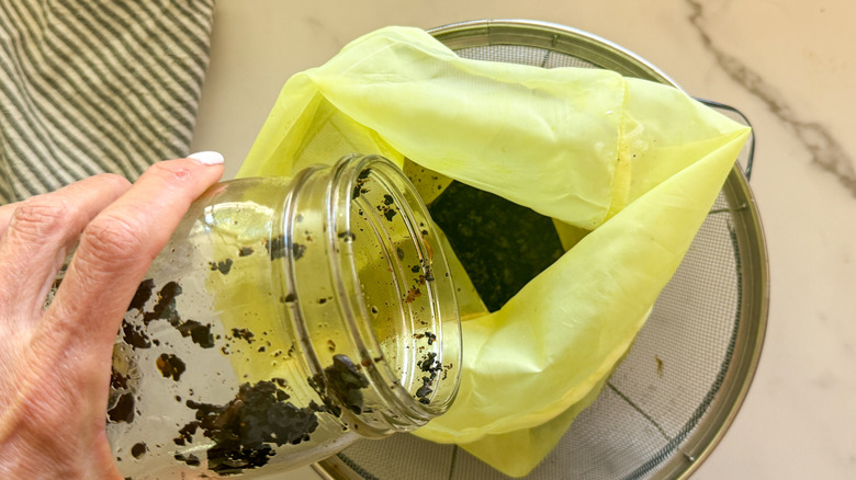 hand pouring coffee into bag