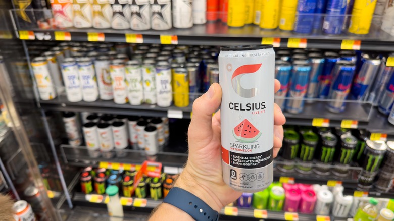 person holding Celsius energy drink