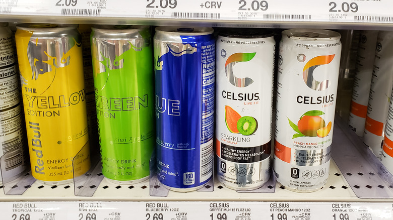 cans of red bull and celsius on store shelf