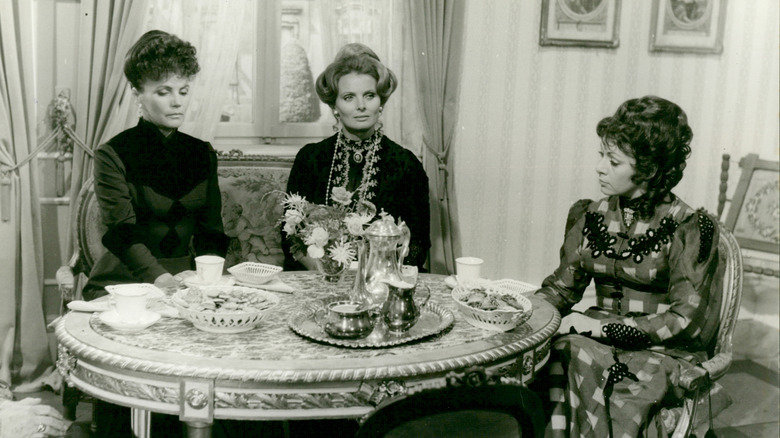 Three women sitting at tea table