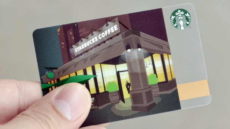 person holding starbucks gift card