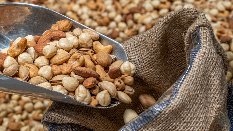 Scoop pouring nuts into bag