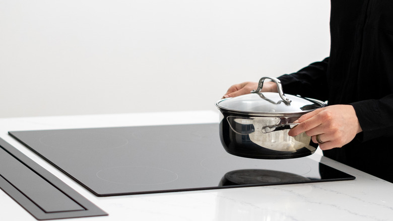 pan being placed on induction cooktop