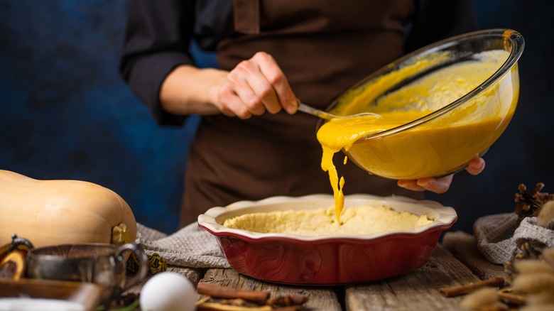 Pumpkin pie batter poured into a crust