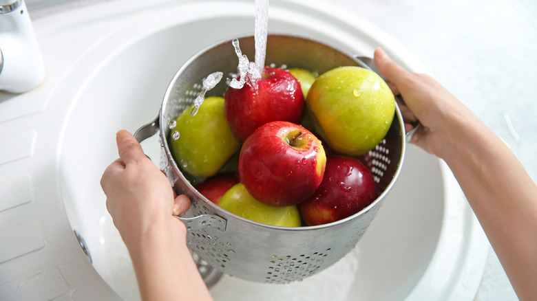 Apples being washed in colander