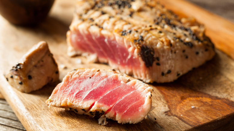 seared tuna steak on cutting board