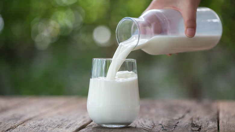 milk being poured into a glass