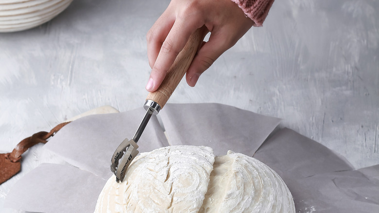 Hand scoring bread dough 