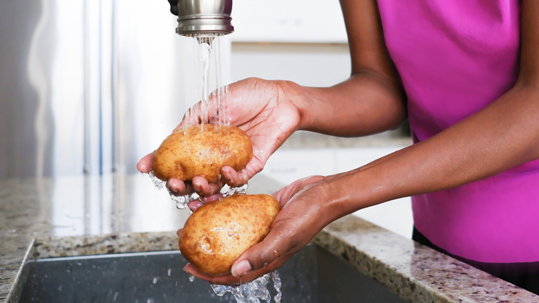 Home cook washing potatoes 