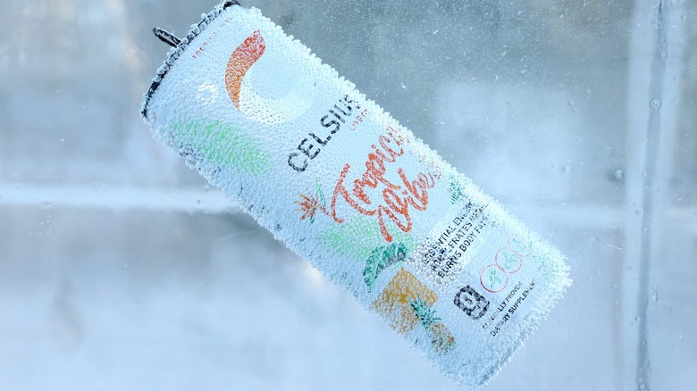A can of Celsius energy drink chilled in ice