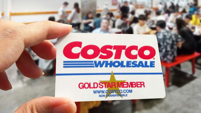 Hand holding Costco membership card