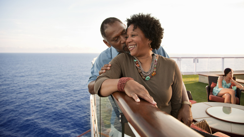 couple on cruise ship, kiss enjoying retirement