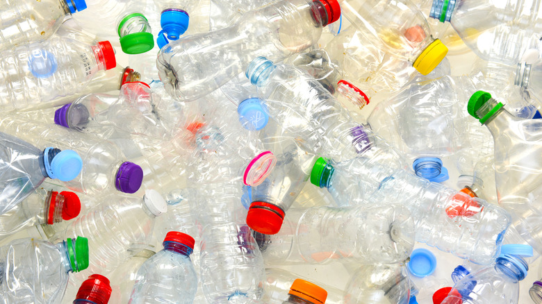 A pile of used clear plastic beverage bottles