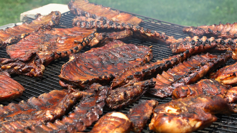 Spread of barbecued ribs on grill