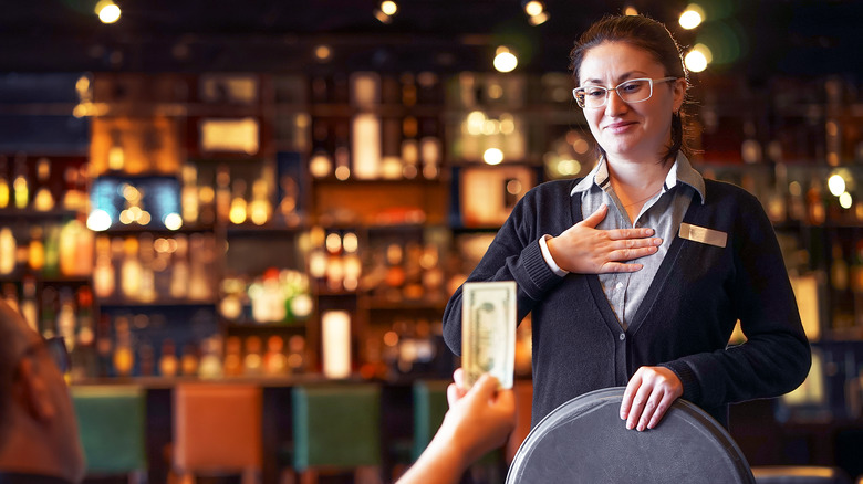 waitress receiving a cash tip