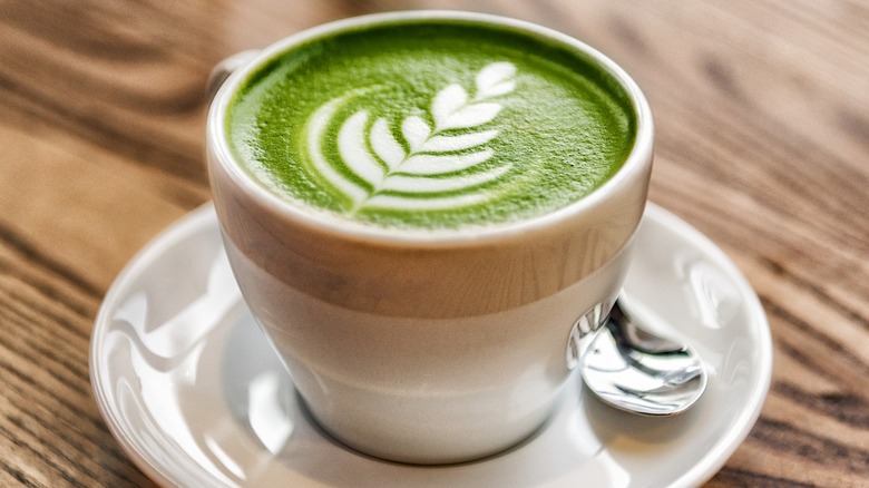 A cup of prepared matcha on a plate 