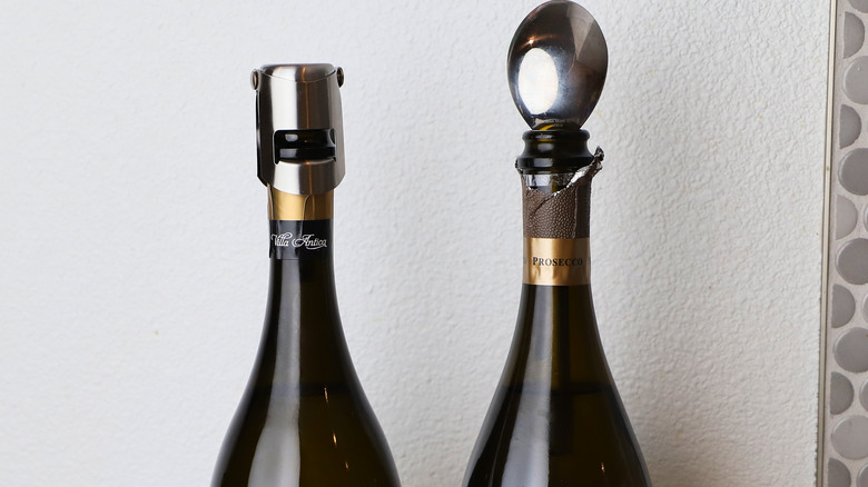 Two bottles of open sparkling wine