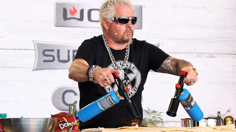 Guy Fieri cooking with blow torches