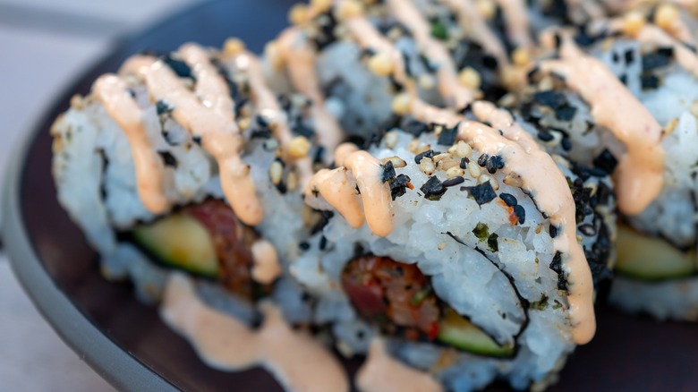 sushi with spicy mayo and sesame seeds