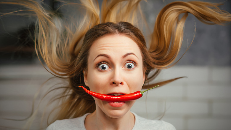 Woman with pepper in mouth 