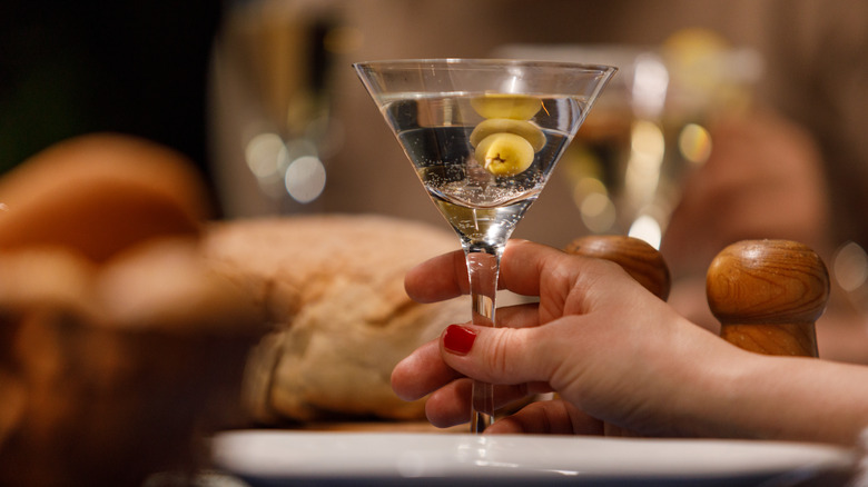 womans hand with martini