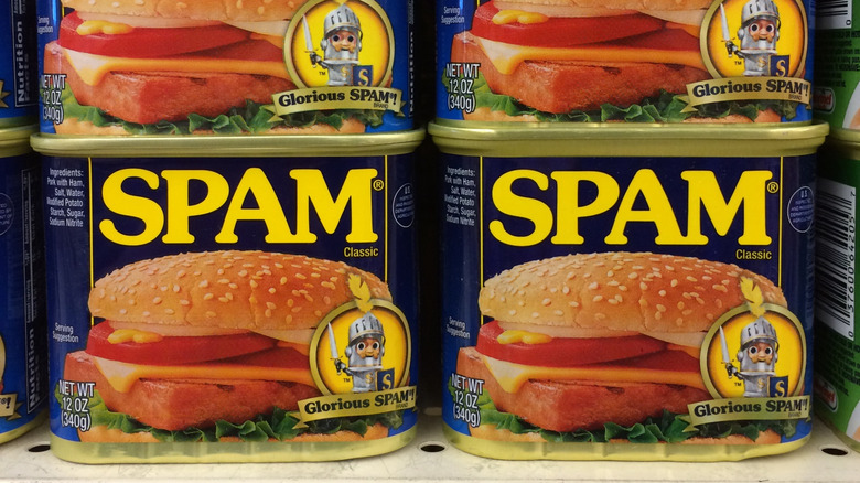 Cans of regular Spam on a shelf