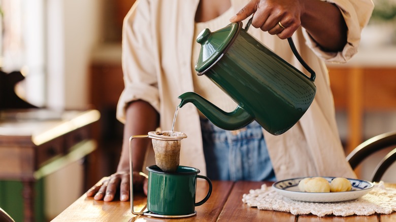 enamel coffee pot being poured