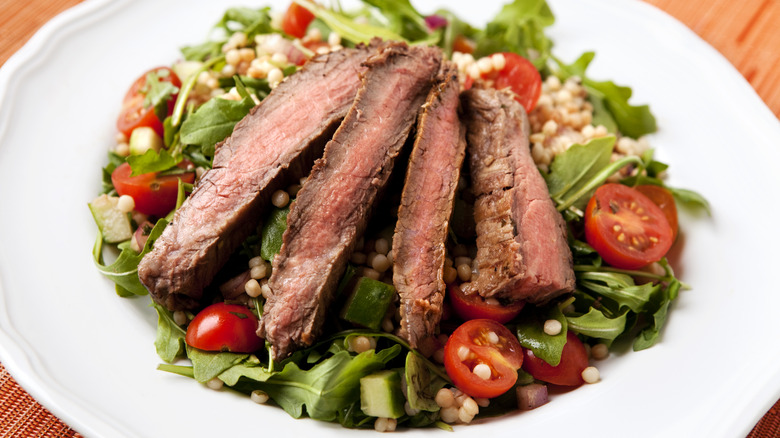 sliced steak tenderloin on salad