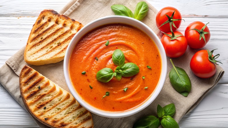 bowl of tomato soup and fresh tomatoes