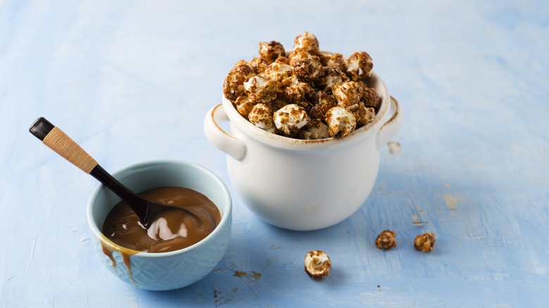 Caramel corn next to a bowl of sauce