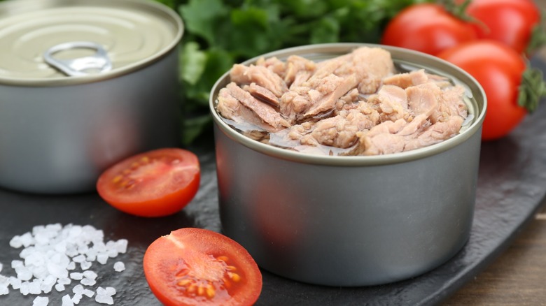 cans of tuna on cutting board