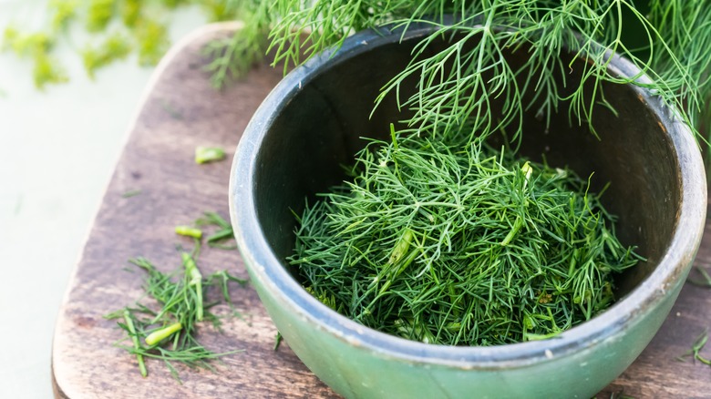 Fresh dill against a cutting board