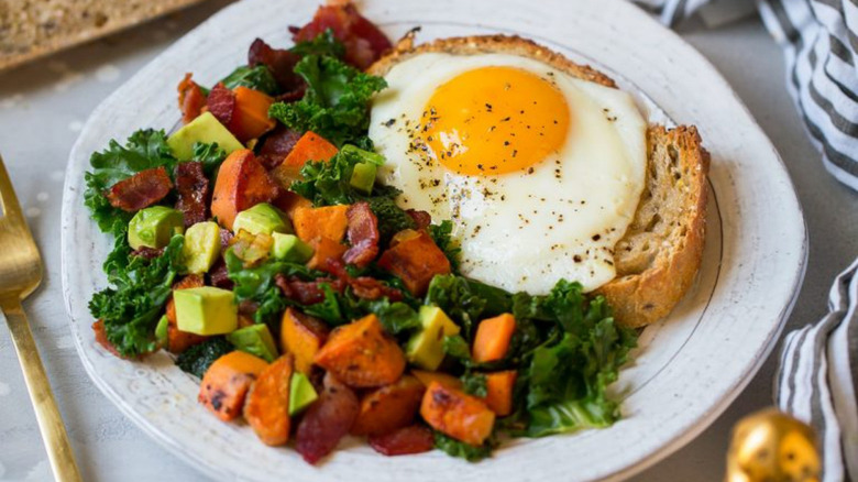 Sweet potato hash with eggs, kale, and toast