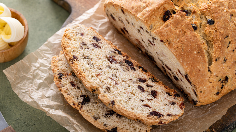 Irish soda bread loaf and slices on paper