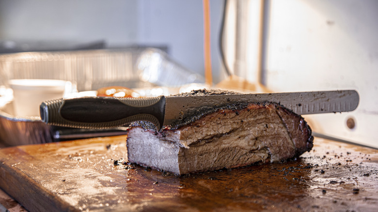 Brisket on cutting board with knife