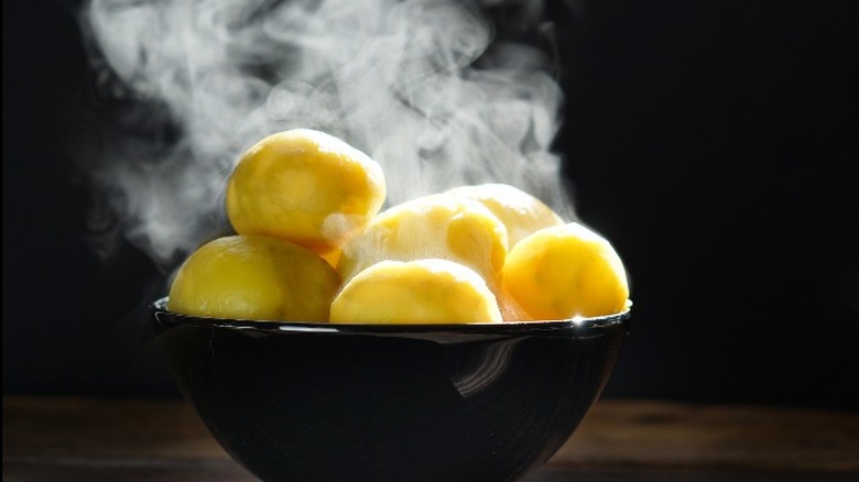 Steaming boiled potatoes in bowl 
