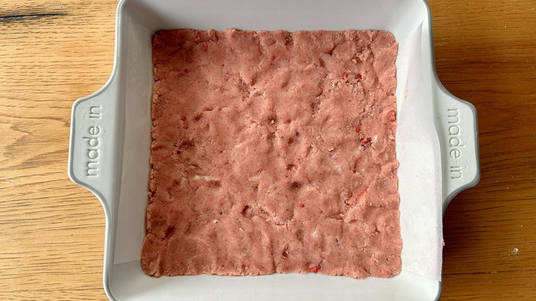 Strawberry shortbread dough in baking dish