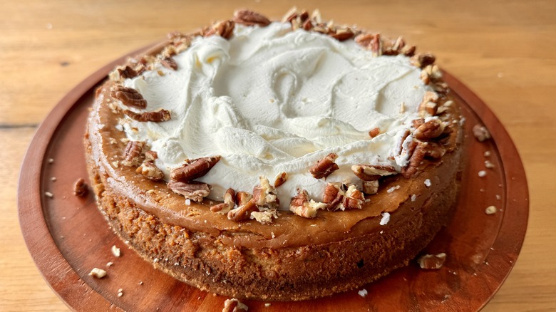 cheesecake with whipped cream and pecans