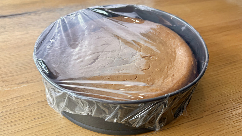 cheesecake covered with plastic wrap