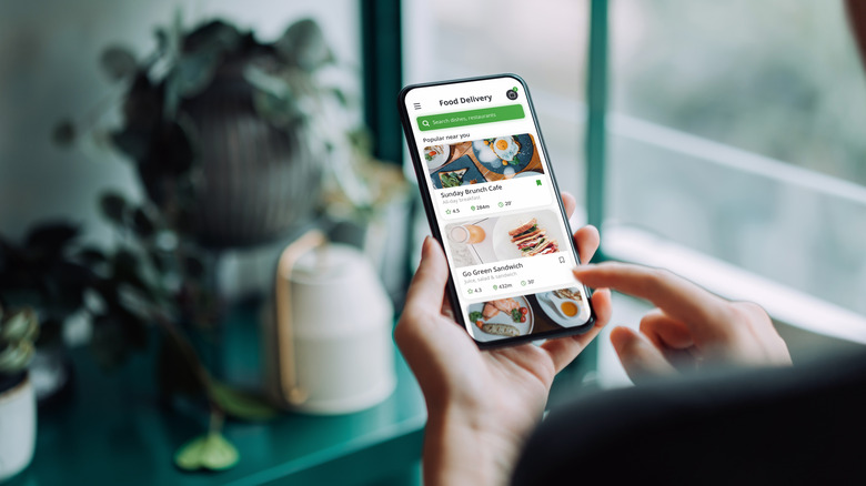 Person ordering delivery on mobile app