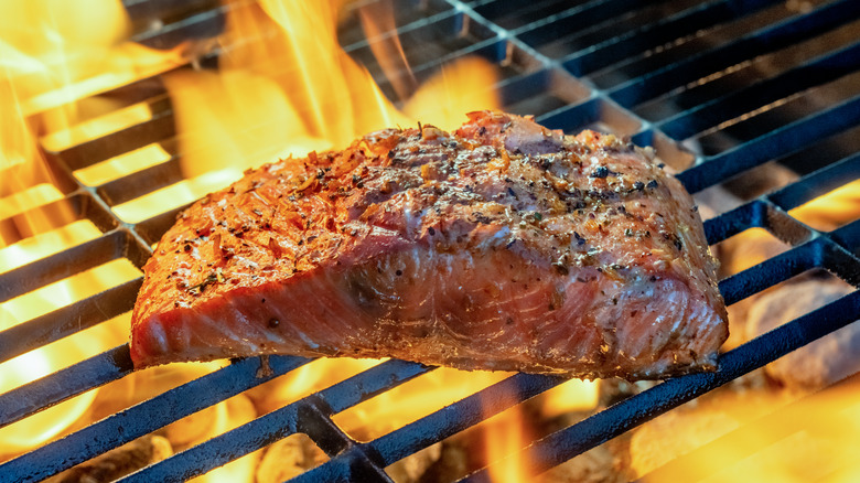 Grilling salmon filet with flames