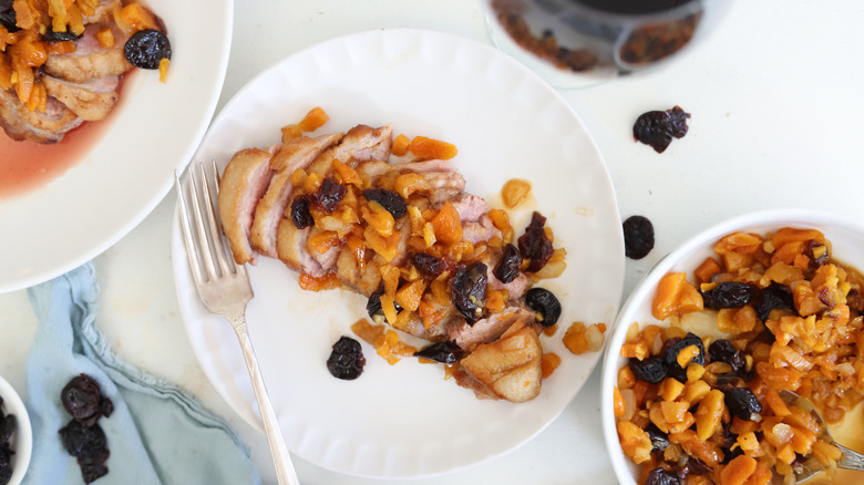 seared duck with apricot chutney on plate