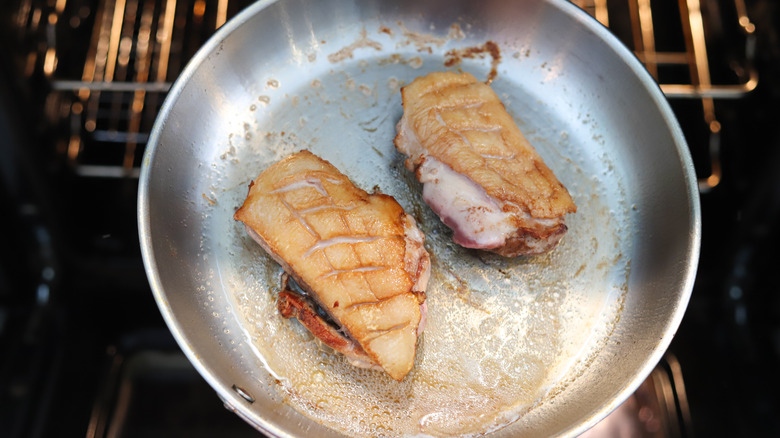 seared duck in pan in oven