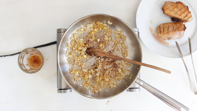 onions and garlic cooking in duck fat