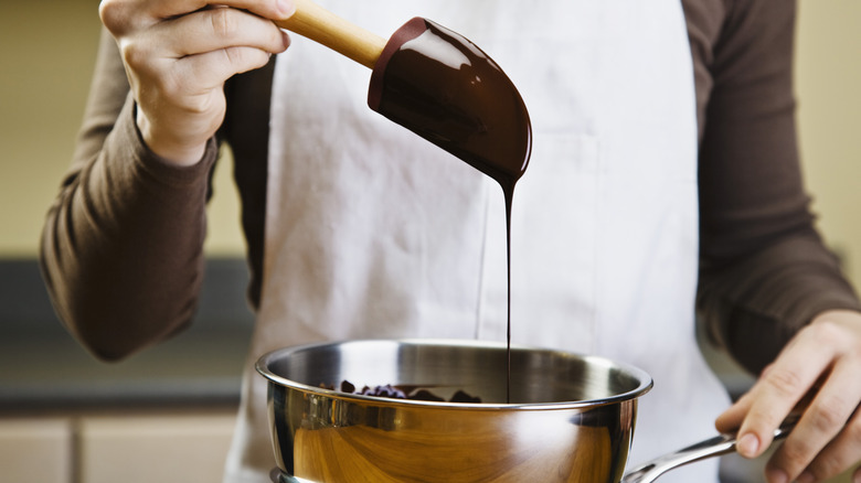 Chef melting chocolate over stove