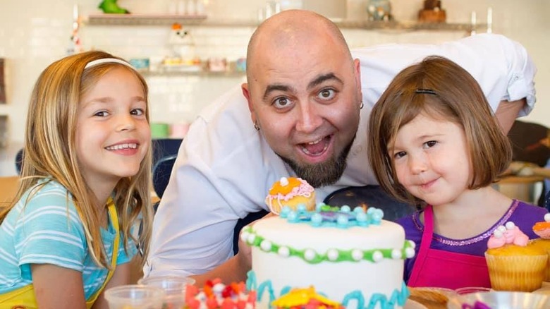 Duff Goldman posing with young bakers