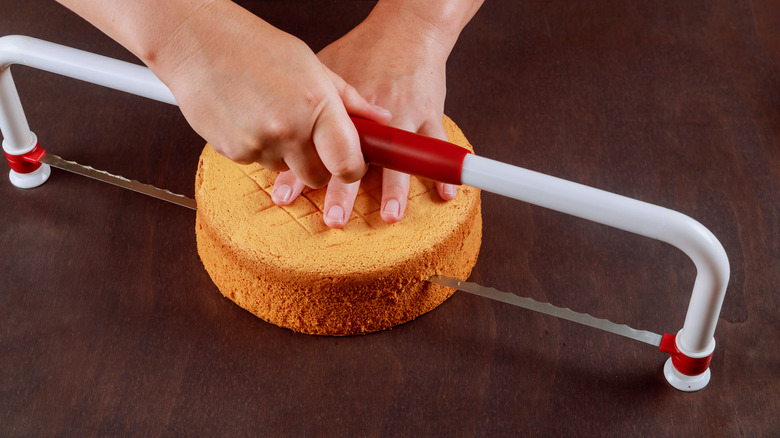 person using cake leveler